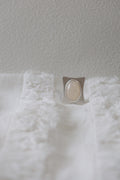 Silver Ring on a white textured surface