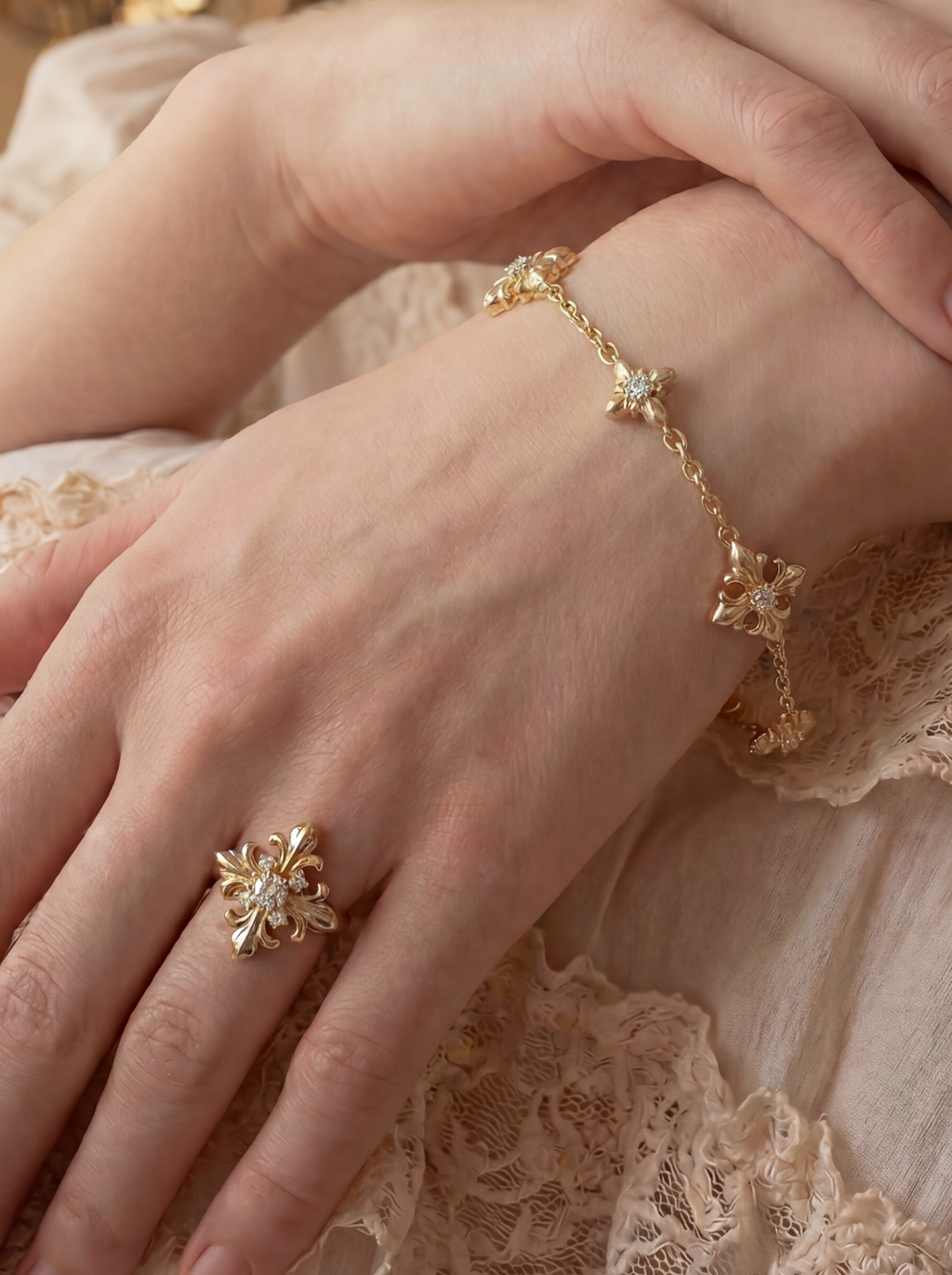 Close-up of a woman's hands wearing gold jewelry with a soft, blurred background.