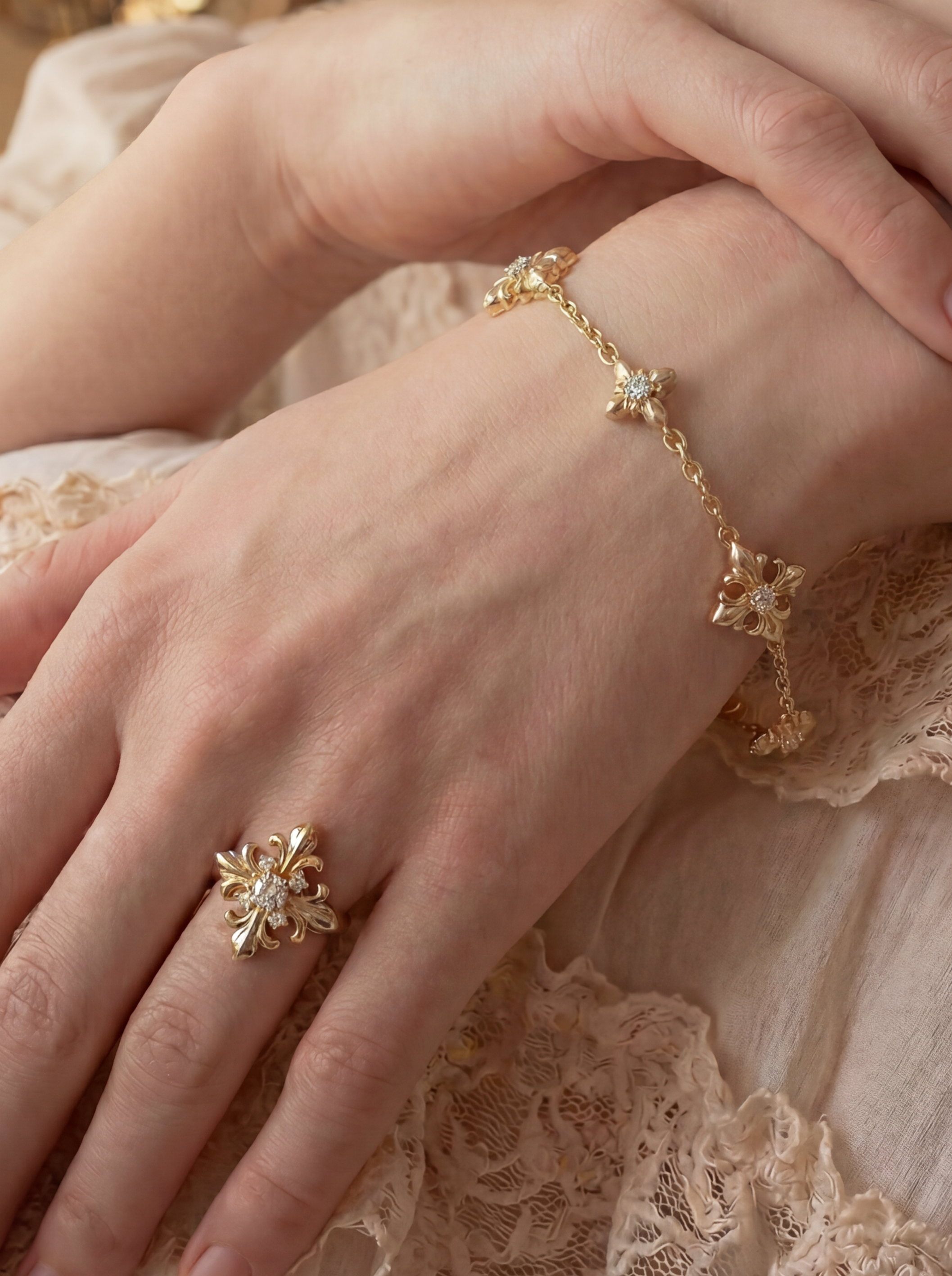 Close-up of a woman's hands wearing gold jewelry with a soft, blurred background.