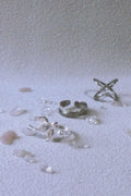 Silver rings on a textured white surface
