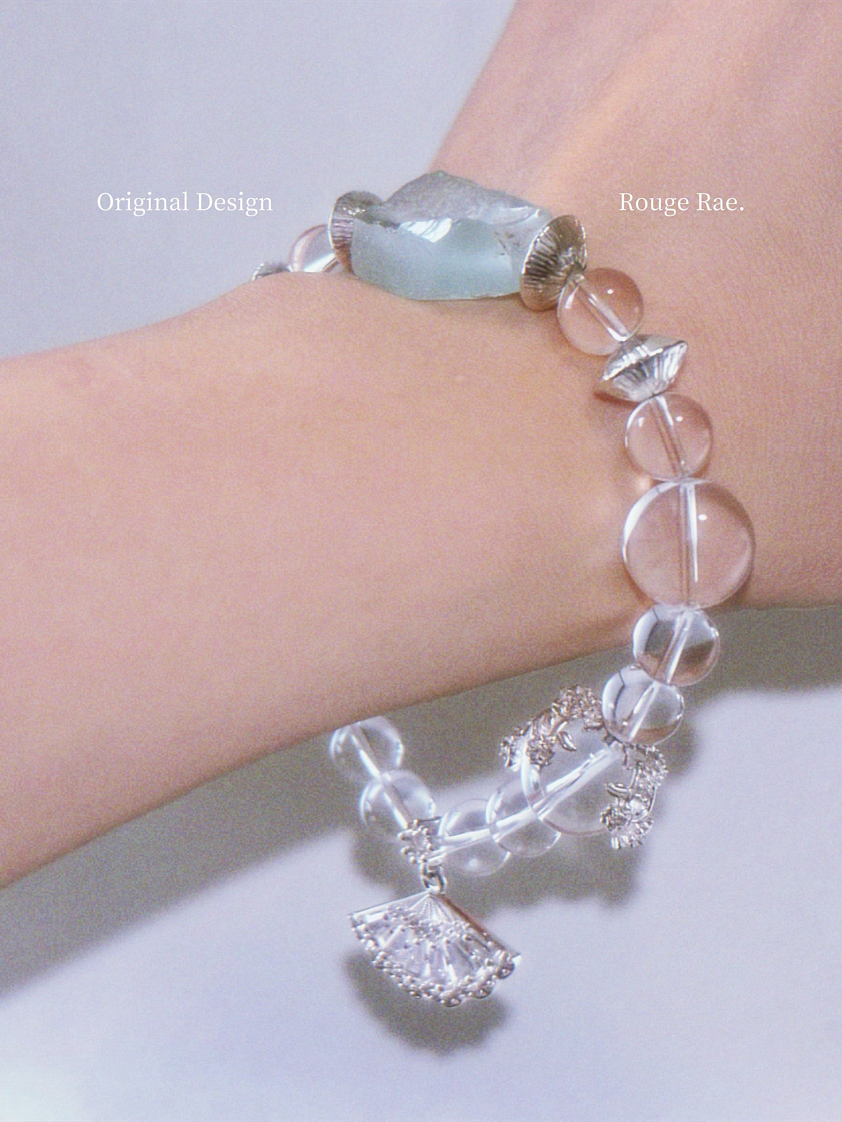 Bracelet with clear and mint beads on a wrist