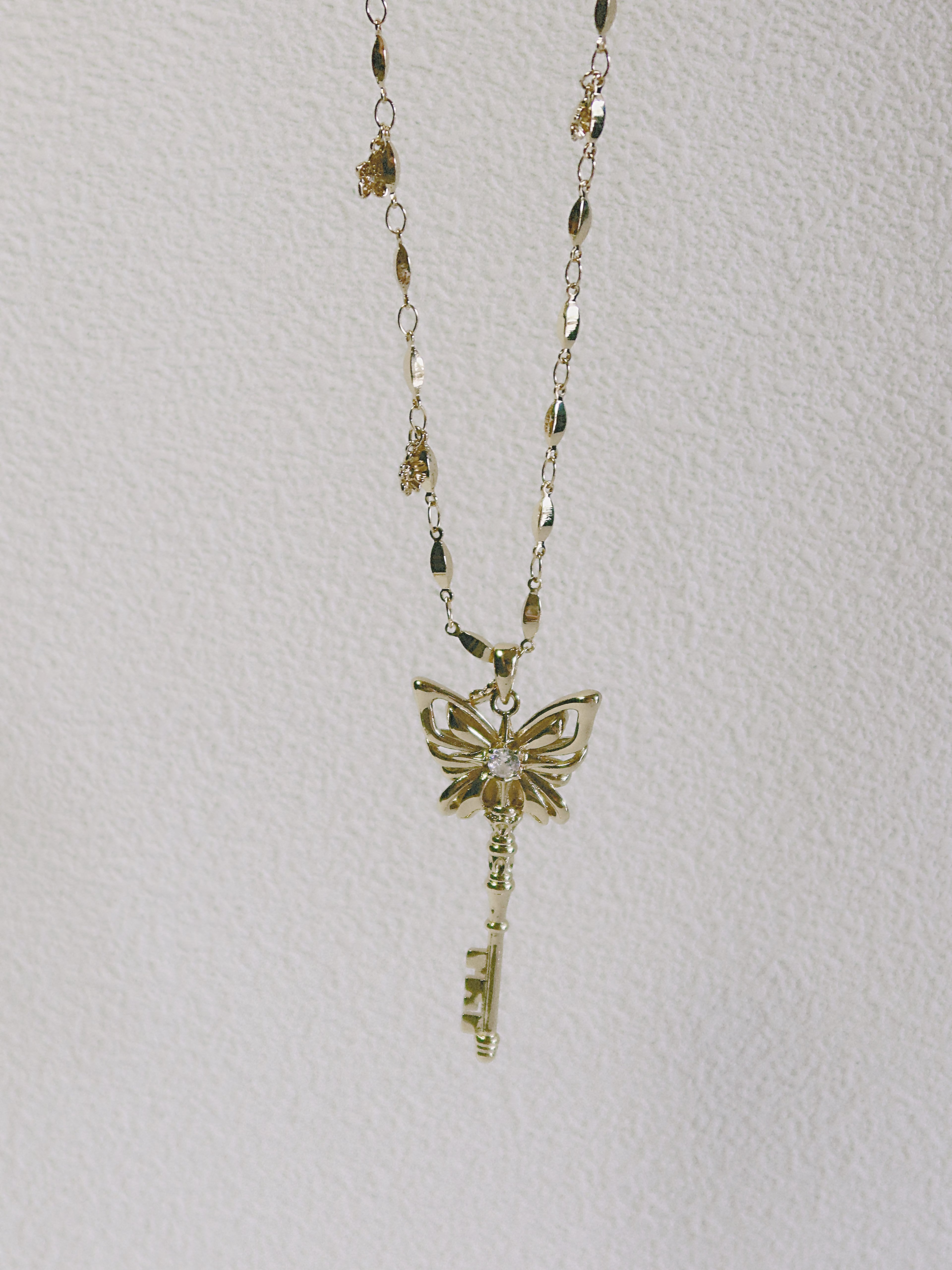 The Butterfly Key. Radiant Pendant Necklace