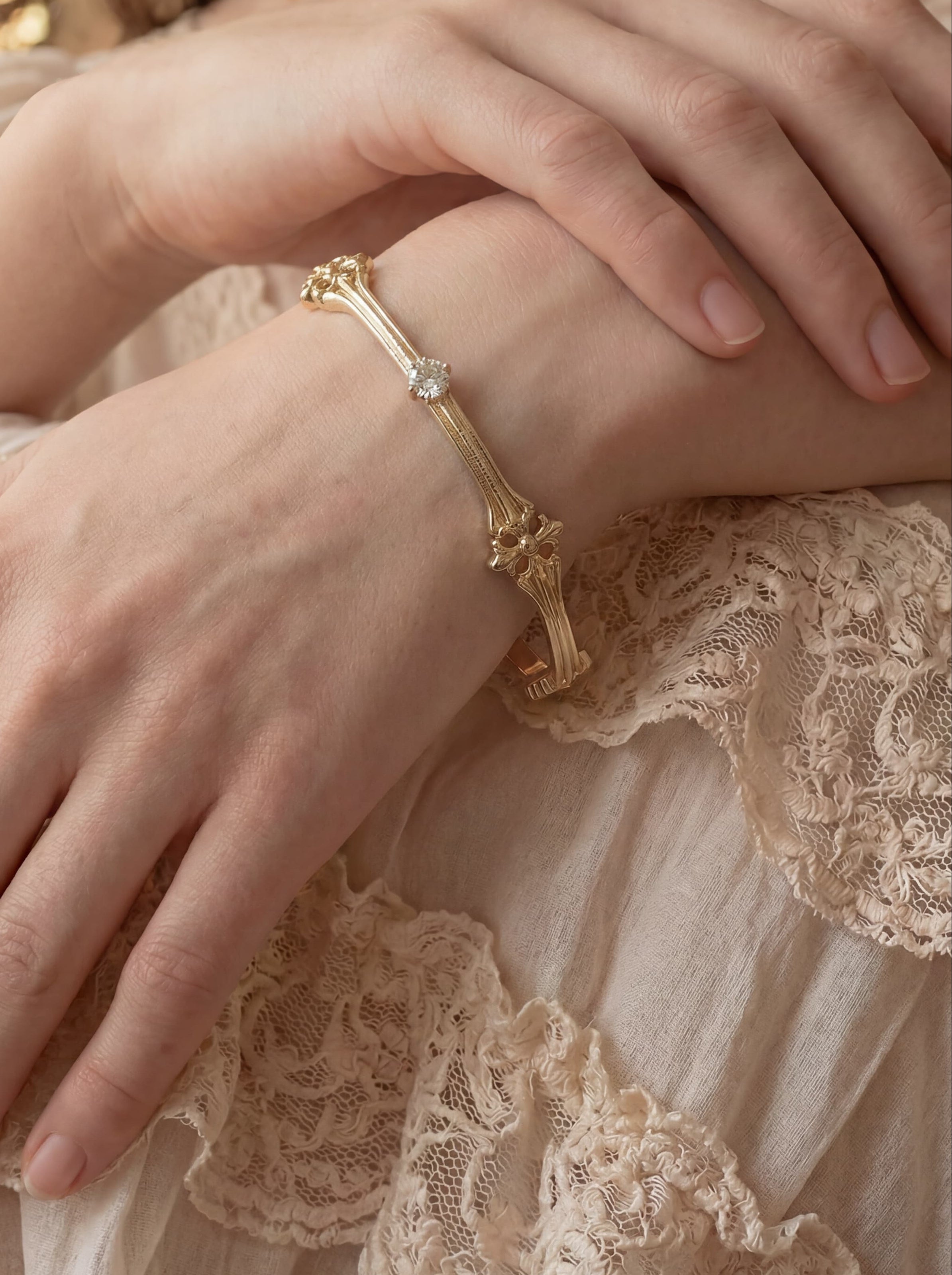 Close-up of a person wearing a gold bracelet with a blurred background