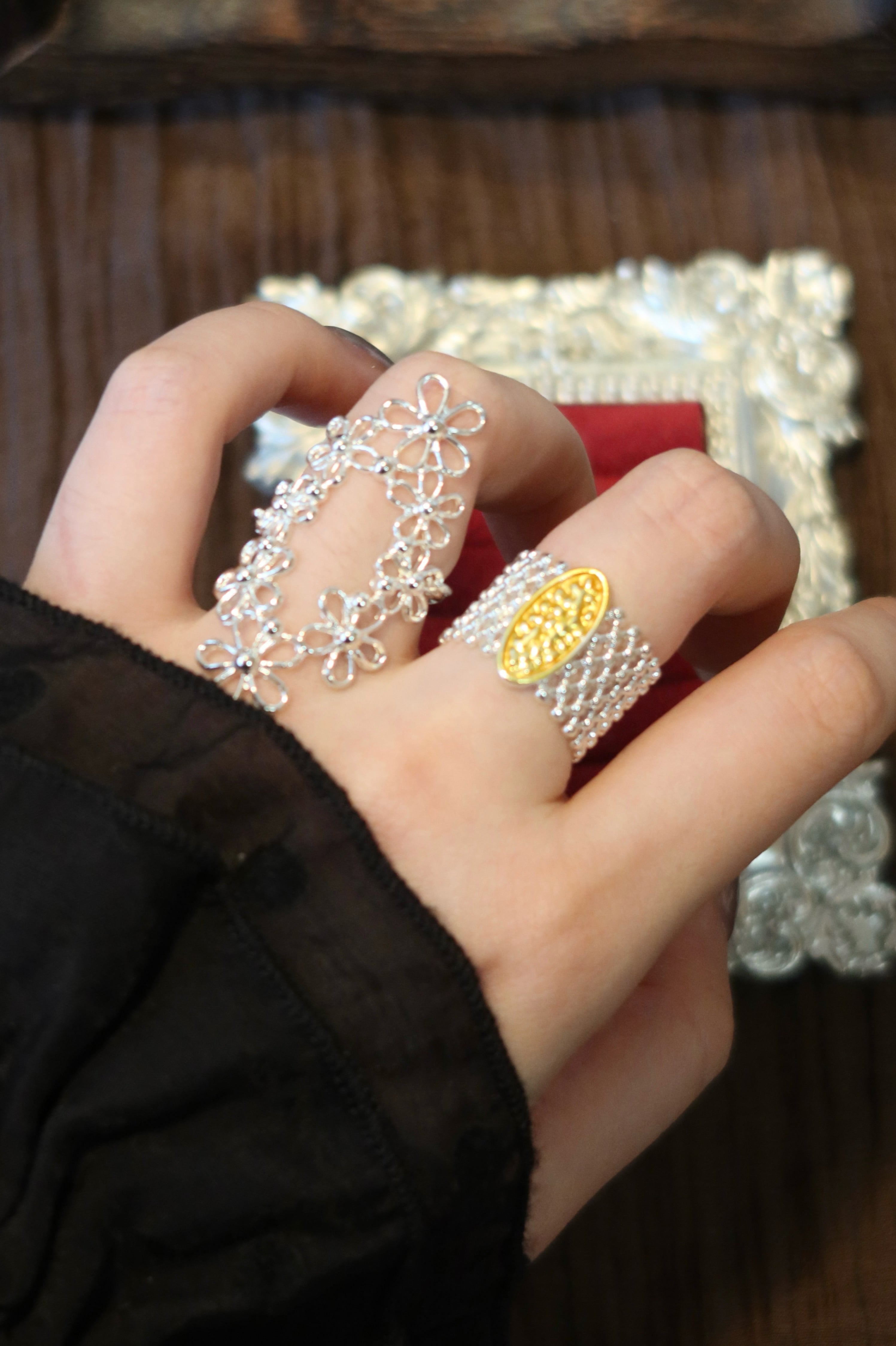 Detailed view of the oval hollow flower ring's intricate silver lace alignment, displaying the delicate openwork filigree inspired by French vintage romantic aesthetics.