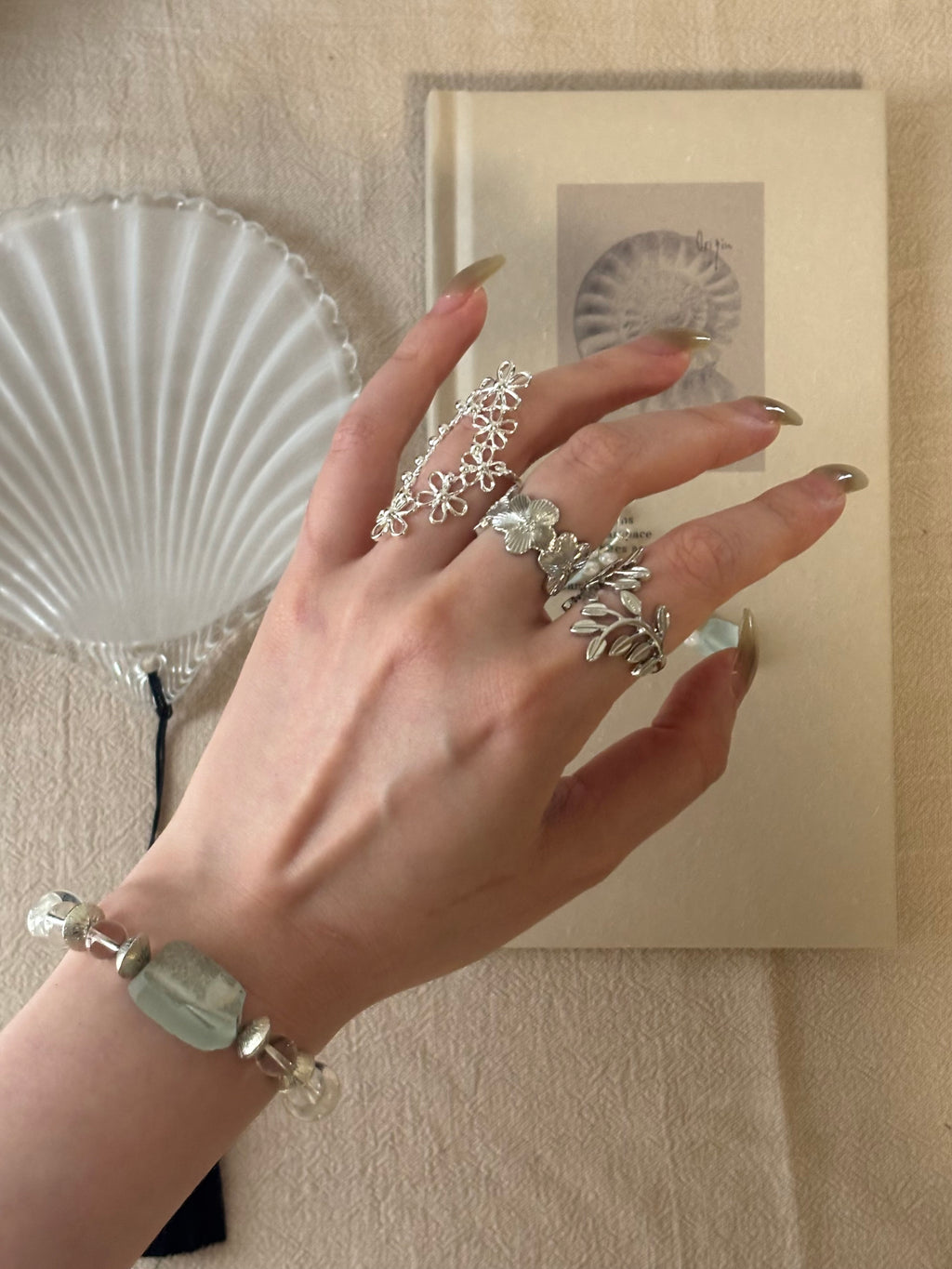 Rouge Rae's silver oval filigree lace ring worn on a model's hand, effortlessly interpreting a free-spirited modern vintage and cottagecore aesthetic.