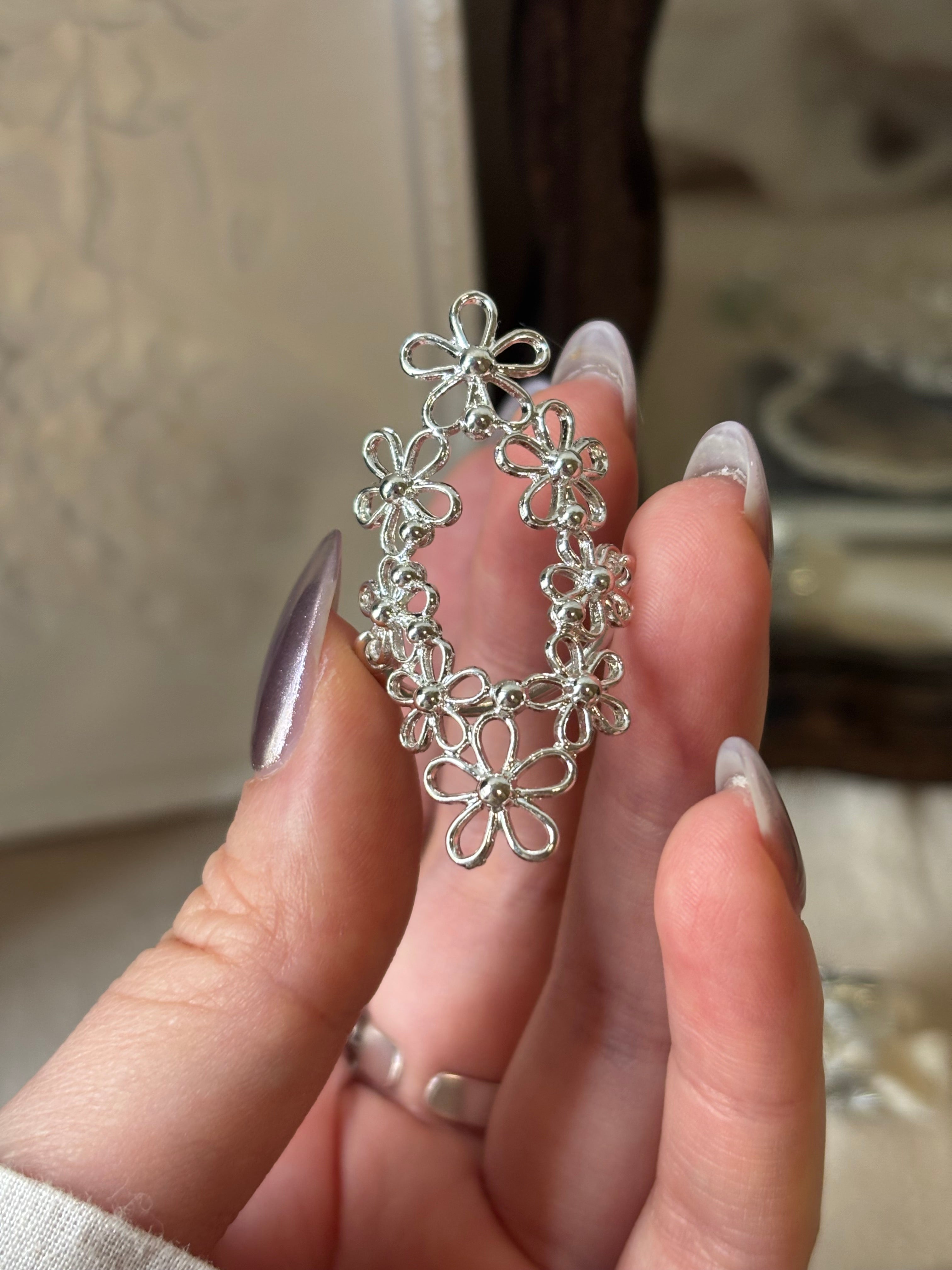 A close-up detail shot of the French vintage oval filigree lace statement ring, showcasing the intricate hollowed-out lace flower pattern and elongated silhouette.
